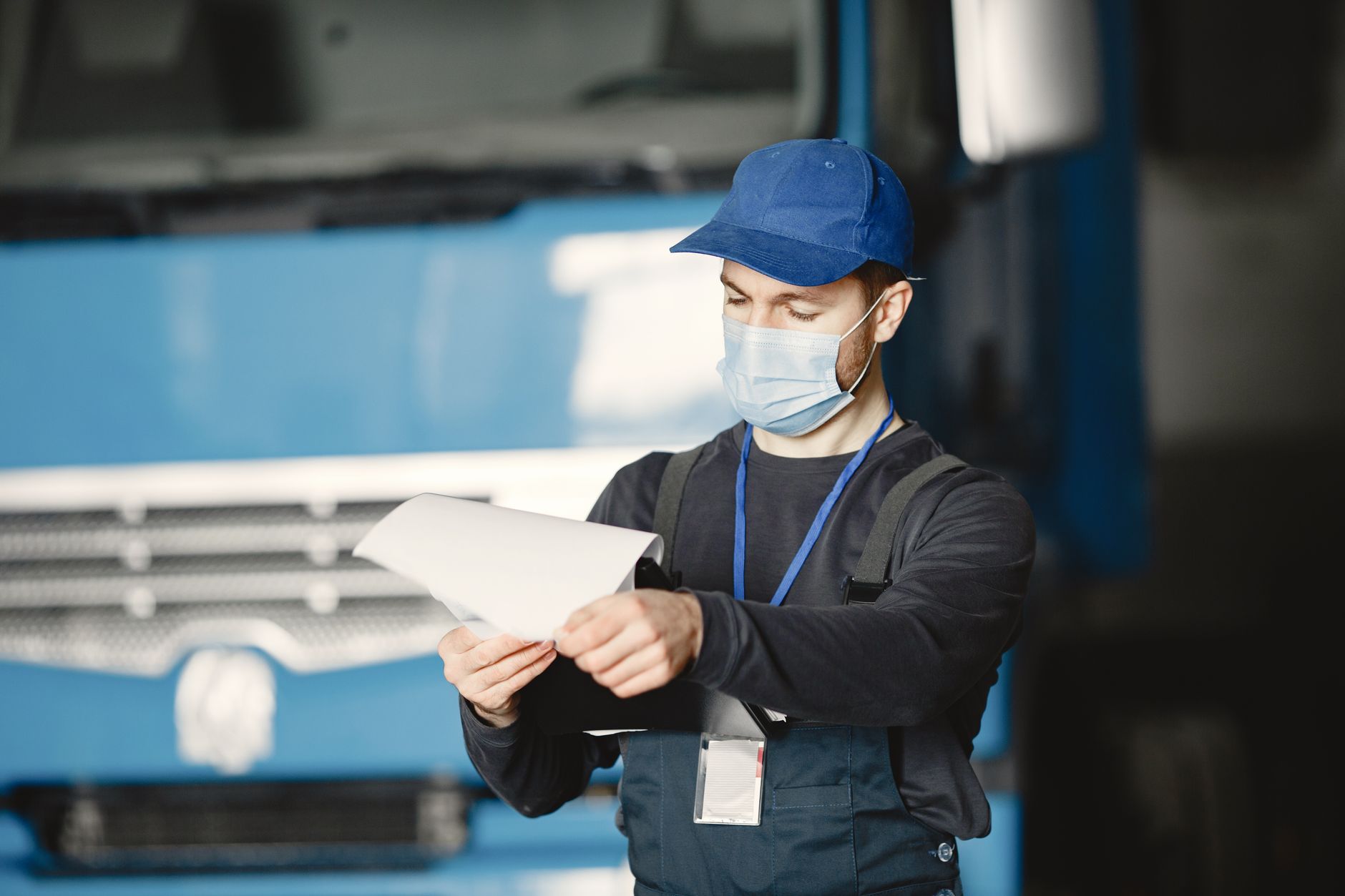 Mechanic reviewing paperwork in the auto workshop